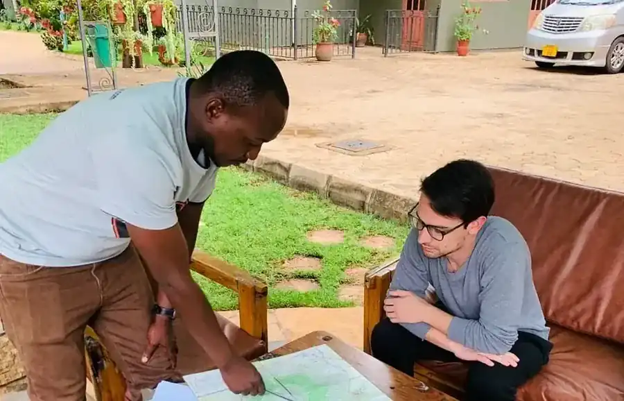 Ascend Tanzania lead guide conducting pre-climb route and medical briefing in Moshi hotel